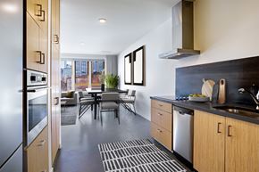 Portland apartment for rent - Kitchen and dining area with a table and chairs and a large window