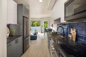 Seattle apartment for rent - a kitchen with stainless steel appliances and a black counter top