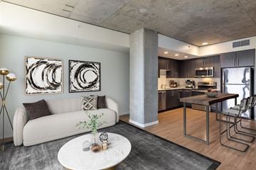Seattle apartment for rent - A modern living room with a white couch and two abstract art pieces on the wall.