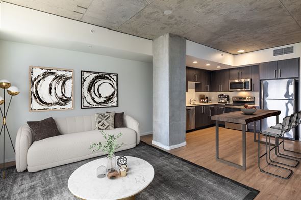 Seattle apartment for rent - A modern living room with a white couch and two abstract art pieces on the wall.