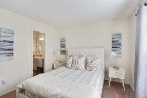 Norcross apartment for rent - A bedroom with a large bed and a painting on the wall.