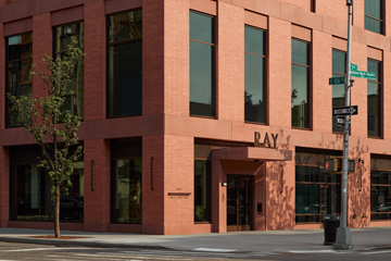 New York apartment for rent - A red brick building with a sign that says "RAY" on the front.