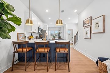 Charlotte townhouse for rent - A kitchen with a bar area and chairs.