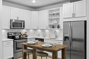 Brentwood apartment for rent - A kitchen with a table and chairs in the middle of the room.