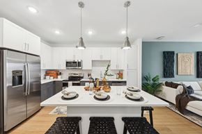 Chattanooga apartment for rent - A modern kitchen with a dining table set for two.