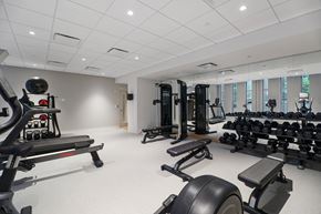 Philadelphia apartment for rent - A spacious gym with a variety of equipment including treadmills, weights, and benches.