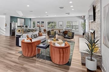 Nashville apartment for rent - A living room with a white couch and orange chairs.