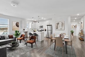 Hackensack apartment for rent - A modern kitchen with a dining table set for four.