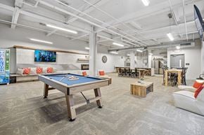 Pittsburgh apartment for rent - A room with a pool table and a TV mounted on the wall.