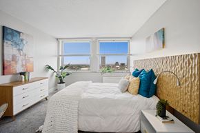 Cleveland apartment for rent - A bedroom with a large bed and a view of the city.