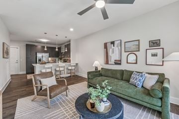Charlotte apartment for rent - A living room with a green couch and a coffee table with a plant on it.