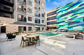 Philadelphia apartment for rent - a pool area with a table and chairs in front of a building