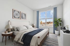 Hackensack apartment for rent - A bedroom with a large bed and two lamps.