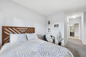 Patchogue apartment for rent - A bedroom with a large bed and a wooden headboard.