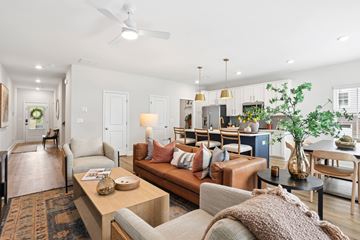 Mcdonough apartment for rent - A living room with a brown couch and a coffee table.