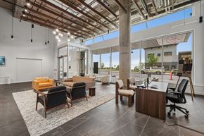 Duluth apartment for rent - A modern office space with a wooden ceiling and furniture.