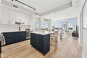 Bethesda apartment for rent - A modern kitchen with dark blue cabinets and a wooden floor.