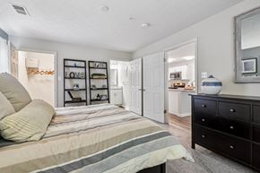 Ellicott City apartment for rent - A bedroom with a bed, dresser, and mirror.
