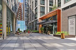 Washington apartment for rent - A modern building with a glass facade and a sign that reads "Restaurant Space for Lease".
