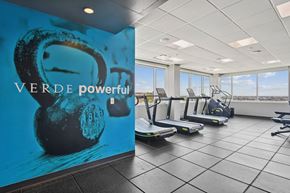 Arlington apartment for rent - A gym with treadmills and a wall mural that says "VERDE powerful".