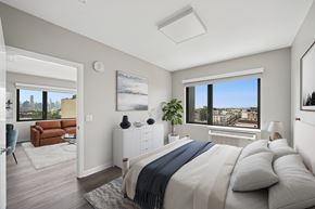West New York apartment for rent - A bedroom with a large bed and a view of the city.