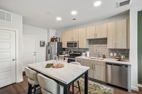 Charlottesville apartment for rent - A modern kitchen with a dining table and chairs.