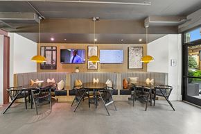 Atlanta apartment for rent - A modern dining area with a long table and chairs.