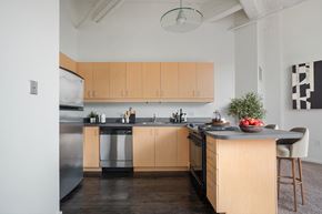 Philadelphia apartment for rent - a kitchen with wooden cabinets and stainless steel appliances and a counter top with a sink