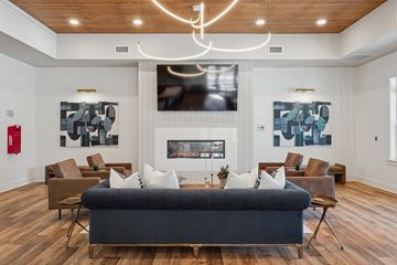 Ridgeland apartment for rent - A modern living room with a large couch and a fireplace.