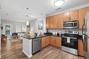 Washington apartment for rent - A modern kitchen with wooden cabinets and stainless steel appliances.