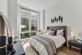 White Plains apartment for rent - A bedroom with a large bed and a large window.