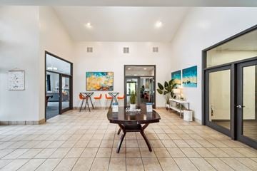 Indianapolis apartment for rent - A spacious living room with a wooden coffee table in the center.