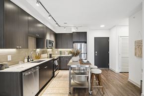 Rockville apartment for rent - A modern kitchen with dark wood cabinets and stainless steel appliances.