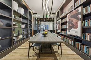 Baltimore apartment for rent - a dining room with a long table and bookshelves