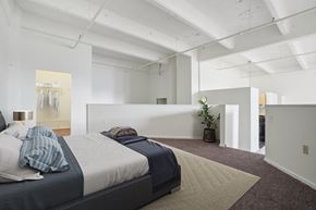 Philadelphia apartment for rent - a bedroom with a bed and a rug in a white room