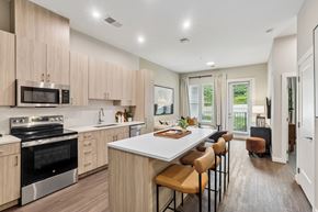 Hyattsville apartment for rent - A modern kitchen with wooden cabinets and stainless steel appliances.
