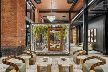 Pittsburgh apartment for rent - A modern living room with a large mirror and a chandelier.