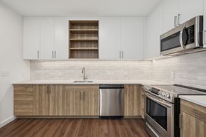 Richmond apartment for rent - A kitchen with wooden cabinets and stainless steel appliances.