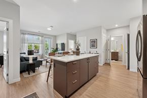 Falls Church townhouse for rent - A modern kitchen with brown cabinets and a white countertop.