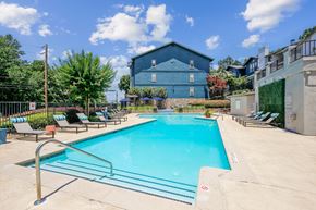 Sandy Springs apartment for rent - A blue building with a pool in front of it.