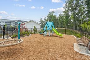 Fredericksburg apartment for rent - A playground with a blue slide and a brown slide.
