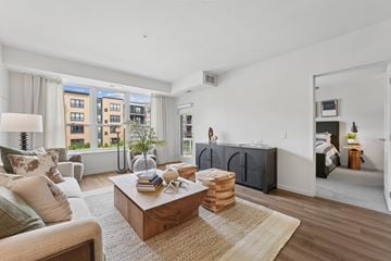 Brooklyn Park apartment for rent - A living room with a brown coffee table and a couch with a white pillow.