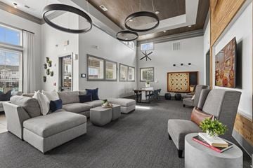 Lebanon apartment for rent - A modern living room with grey sofas and a wooden accent wall.
