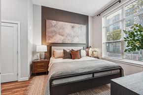 Baltimore apartment for rent - a bedroom with a bed and two windows