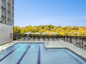 White Plains apartment for rent - A large swimming pool with a diving board and lounge chairs.