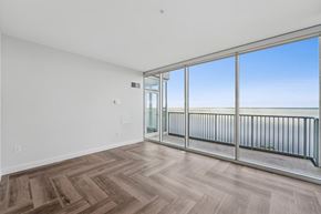 Duluth apartment for rent - A room with a wooden floor and a balcony with a railing.