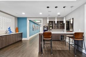 Capitol Heights apartment for rent - A kitchen with a blue wall and brown chairs.