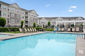Westborough apartment for rent - A large swimming pool in front of apartment buildings.