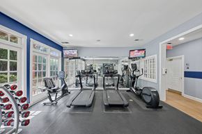 Decatur apartment for rent - A gym with treadmills, elliptical machines, and dumbbells.