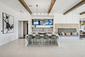Charlottesville apartment for rent - A modern dining room with a bar and a television mounted on the wall.